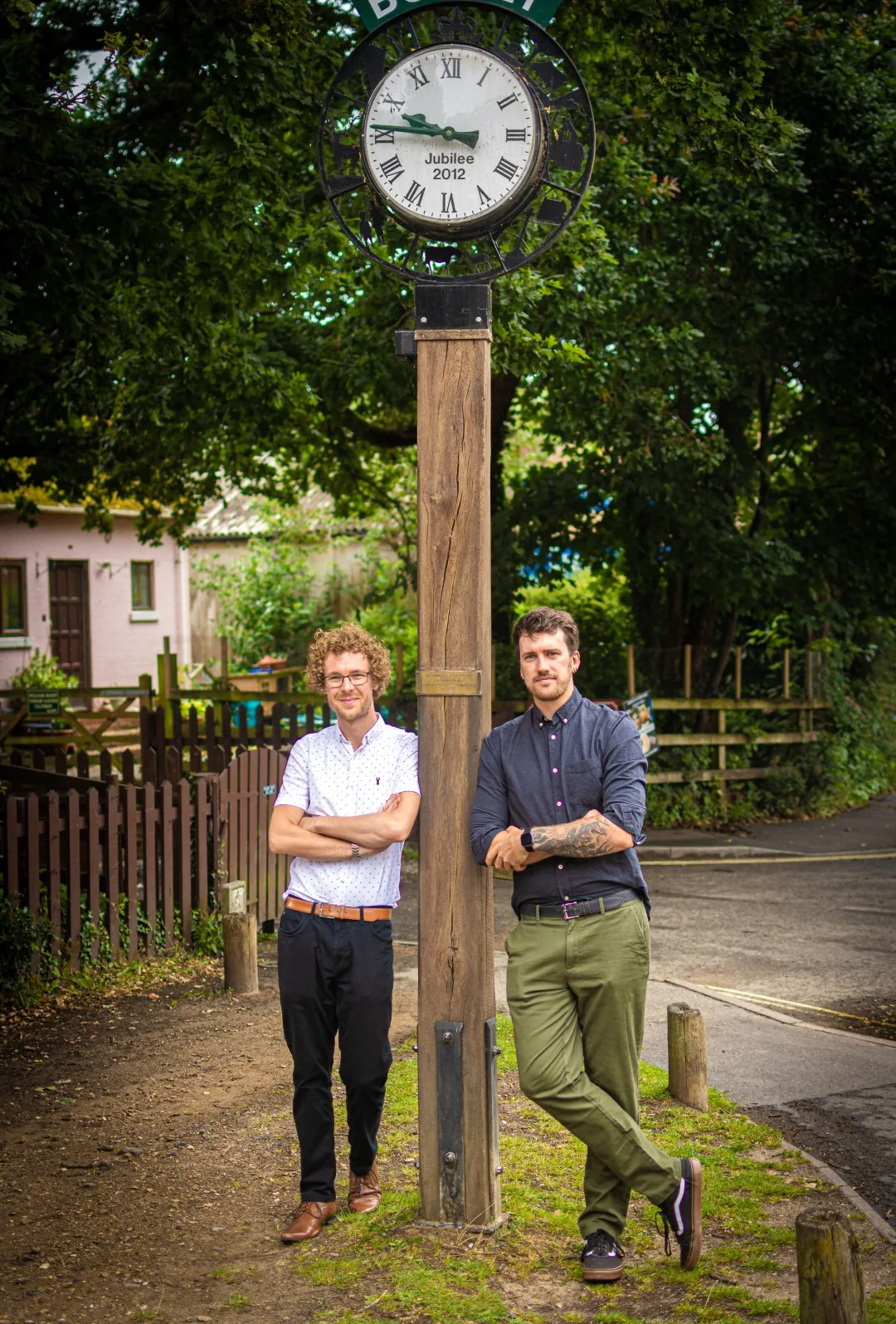 Chris and Matt leaning against a post.